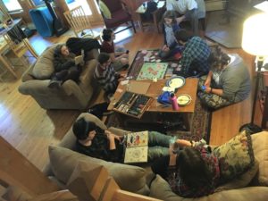 The group spends some down time hanging out in the main cabin--reading, drawing, talking, and playing board games.