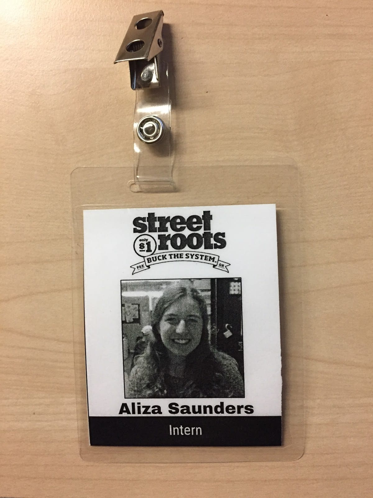 Aliza’s name badge she wears each day at work. Street Roots vendors wear similar badges when they sell their papers.